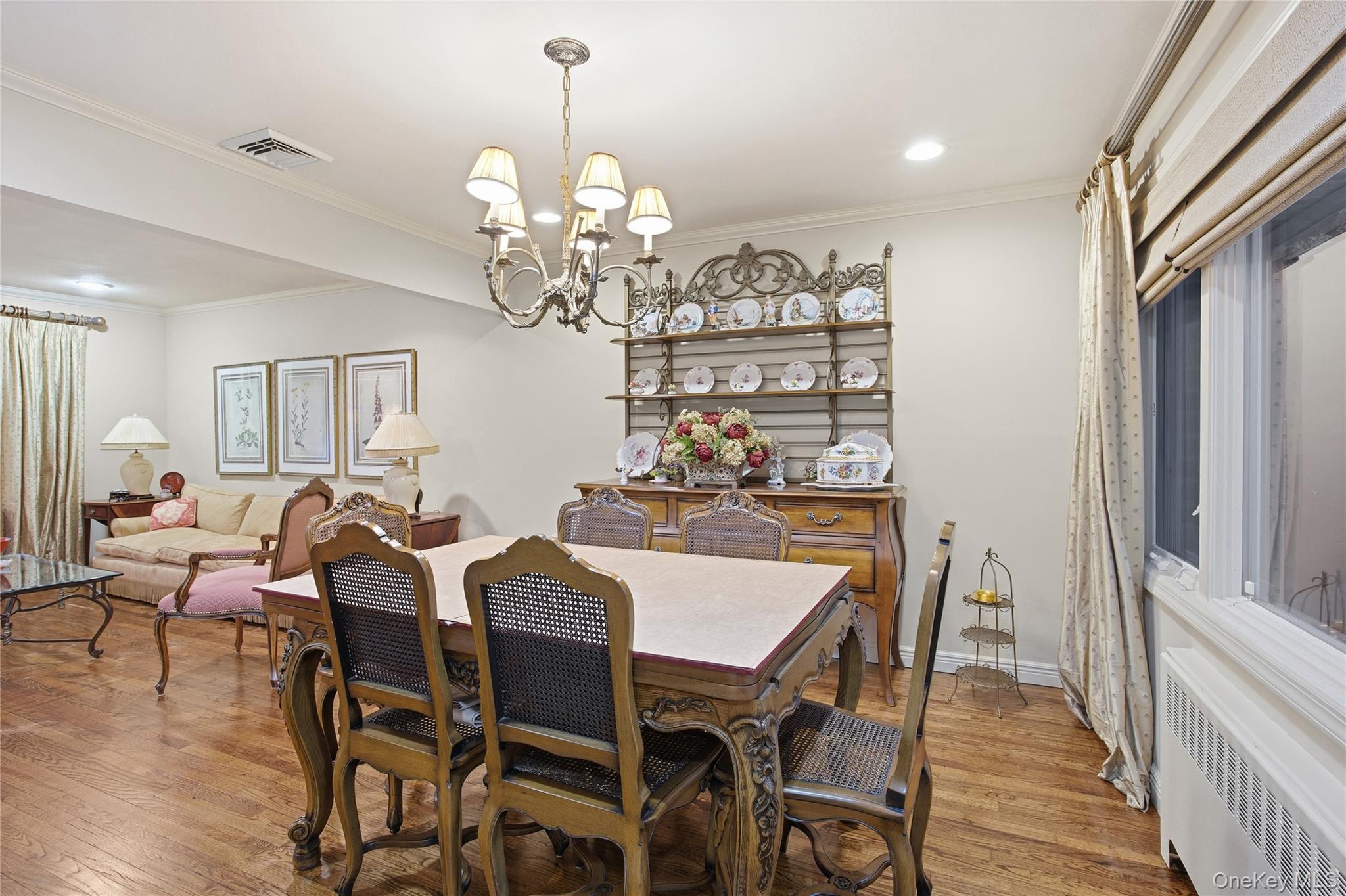 7 Judith Street Plainview, NY 11803 - Photo 14 of 45 Dining room featuring radiator heating unit, ornamental molding, light wood-style flooring, a chandelier, and recessed lighting