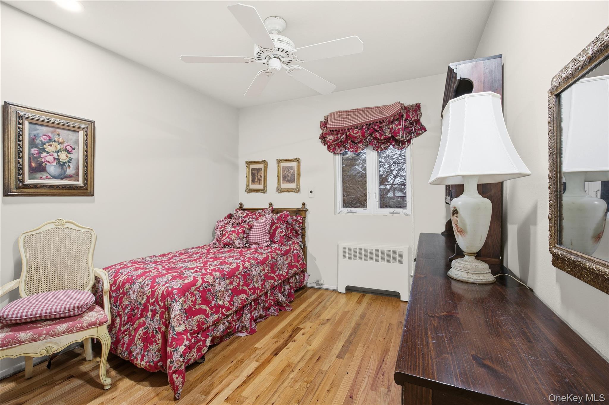 7 Judith Street Plainview, NY 11803 - Photo 26 of 45 Bedroom featuring radiator heating unit, light wood finished floors, and ceiling fan