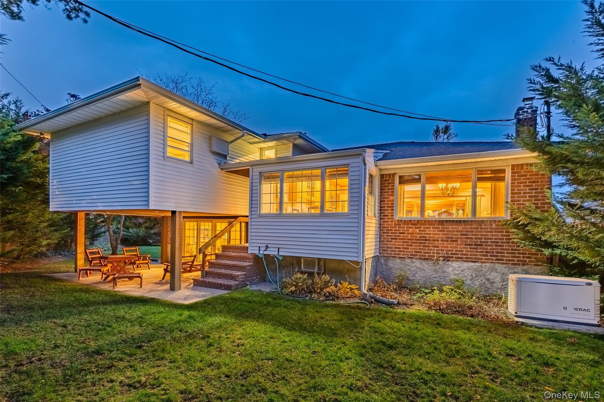 7 Judith Street Plainview, NY 11803 - Photo 3 of 45 Back of house featuring a patio area, brick siding, and a lawn