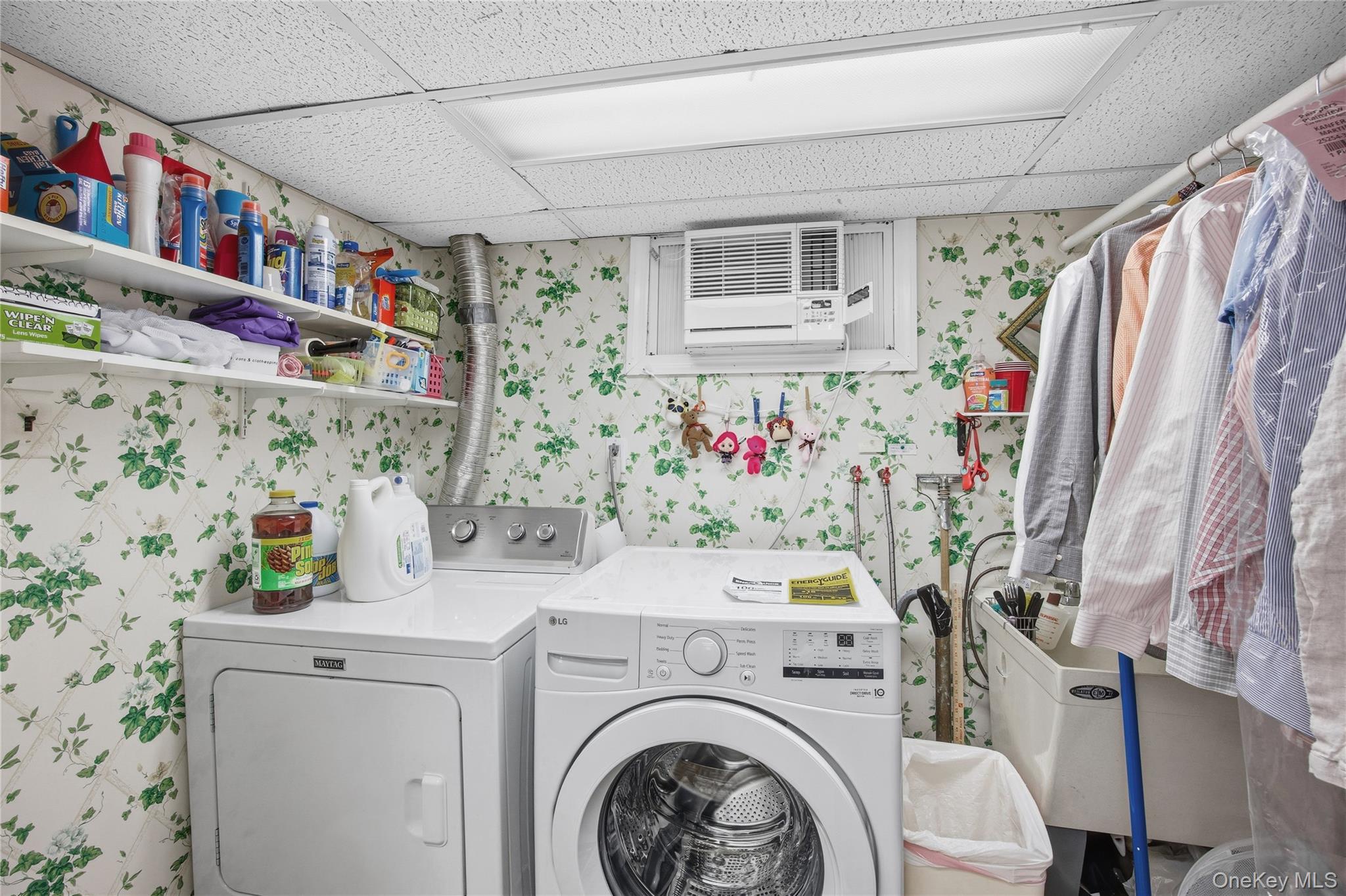 7 Judith Street Plainview, NY 11803 - Photo 31 of 45 Laundry room featuring wallpapered walls, a drop ceiling, separate washer and dryer, and a wall mounted AC