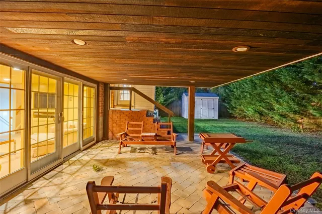 a view of a patio with a table chairs and a backyard