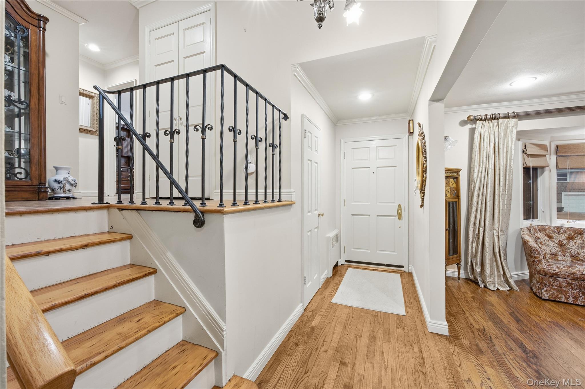 7 Judith Street Plainview, NY 11803 - Photo 9 of 45 Foyer entrance featuring wood finished floors, stairway, crown molding, and recessed lighting