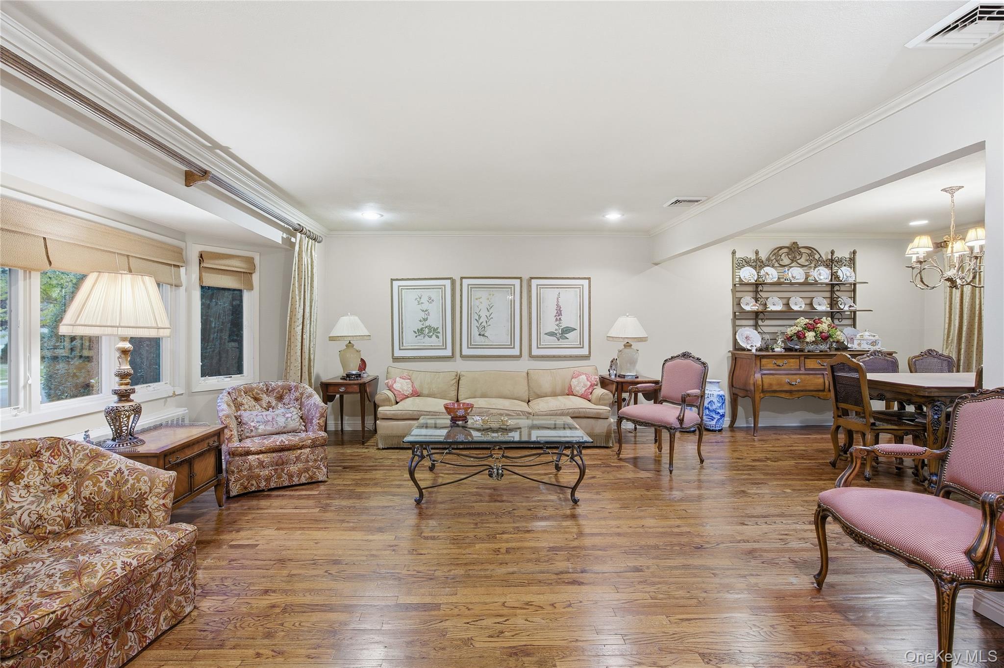 7 Judith Street Plainview, NY 11803 - Photo 10 of 45 Living room featuring ornamental molding, wood finished floors, a chandelier, and recessed lighting