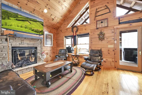 a living room with furniture a fireplace and a flat screen tv