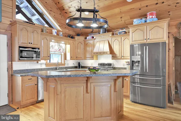 a kitchen with a stove a counter space dining table and chairs