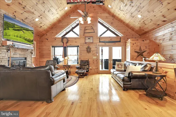 a living room with stainless steel appliances kitchen island granite countertop furniture and a kitchen view