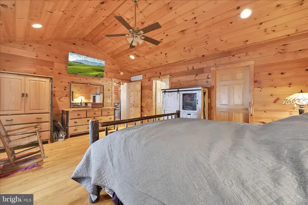 a living room with patio furniture a fireplace and a flat screen tv