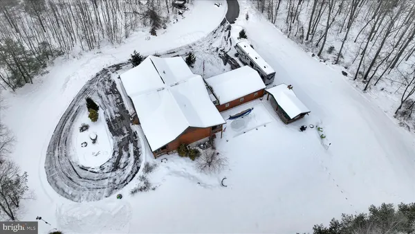 an aerial view of a house with yard and mountain view in back