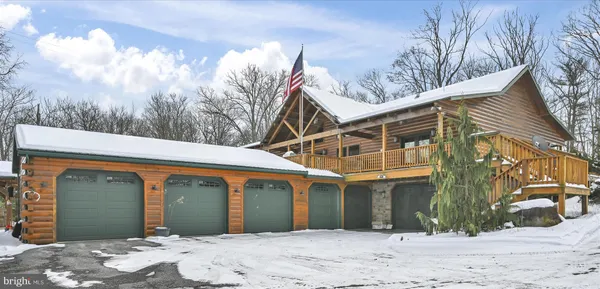a view of a house with a yard covered in snow