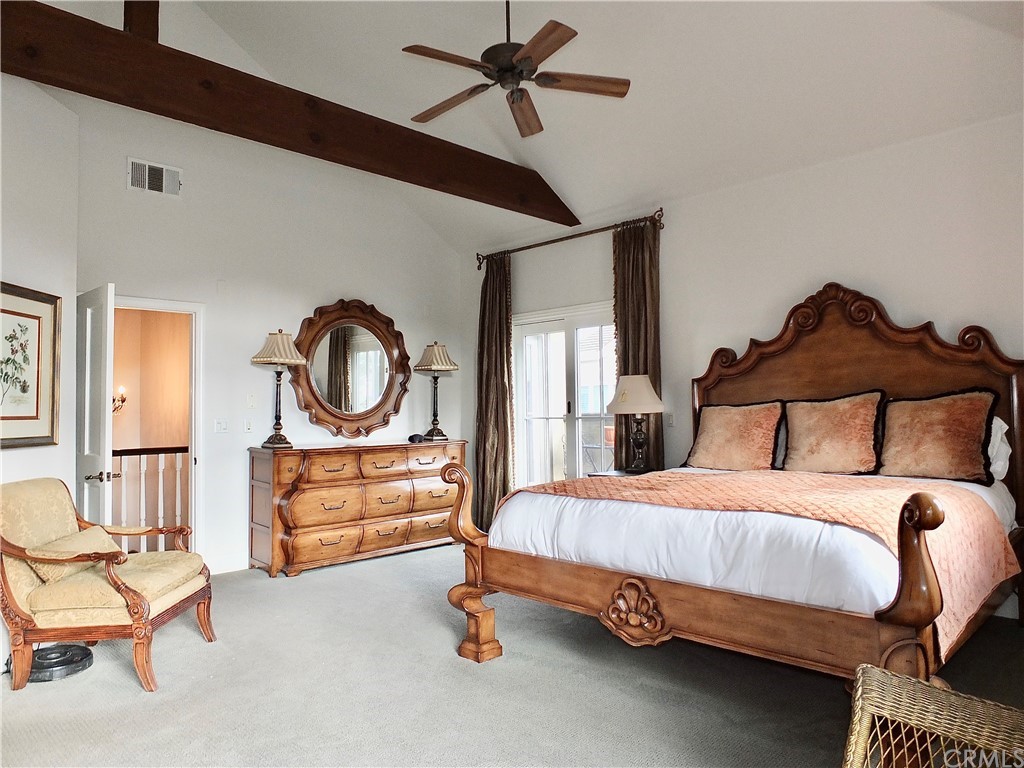 5273 Appian Way Long Beach, CA 90803 - Photo 21 of 34 a bedroom with a bed and a chandelier