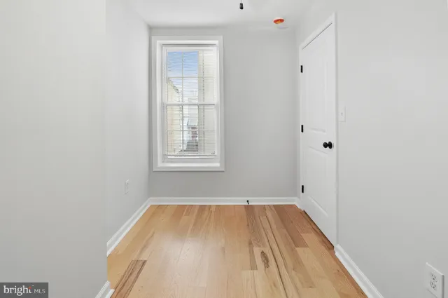 a view of a room with wooden floor and windows