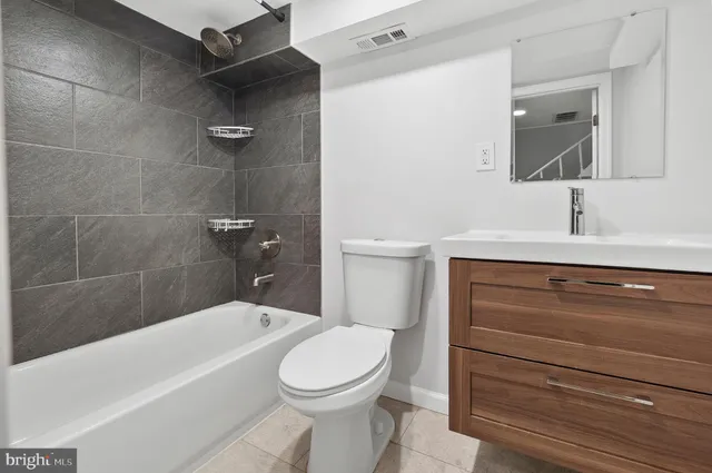 a bathroom with a sink a toilet and bathtub