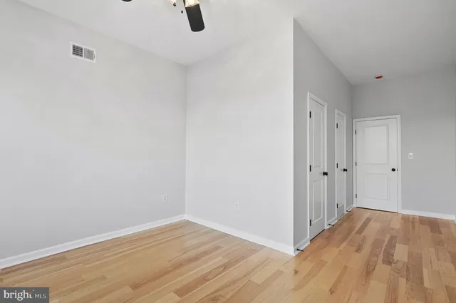 a view of a room with wooden floor