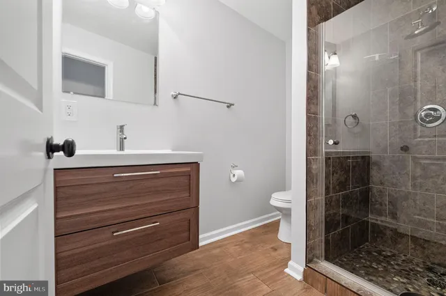 a bathroom with a toilet a sink and shower