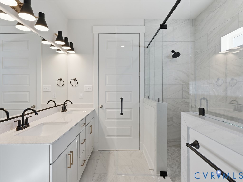 1711 Reed Marsh Lane Goochland, VA 23063 - Photo 12 of 25 a bathroom with a double vanity sink a mirror and shower