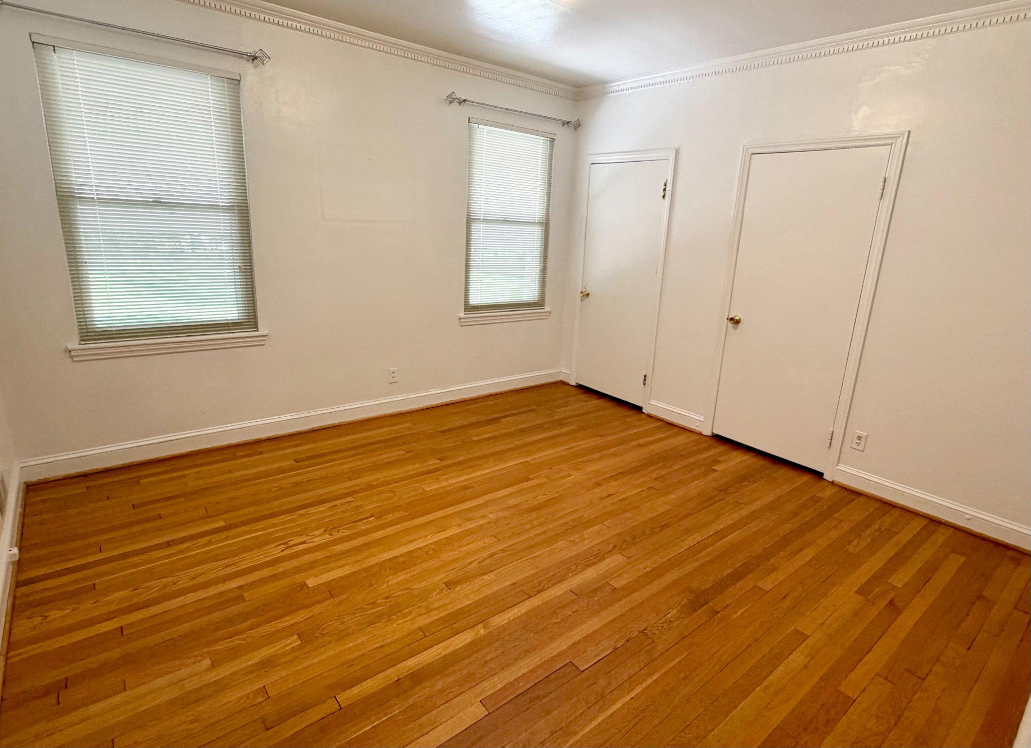 6318 Winner Avenue Baltimore, MD 21215 - Photo 28 of 75 an empty room with wooden floor and windows