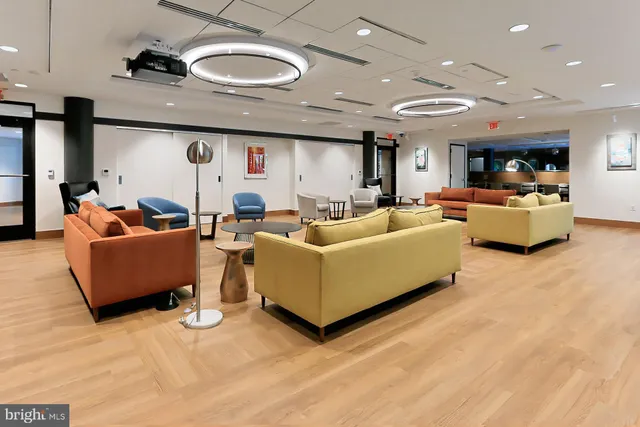 a living room with furniture and kitchen view