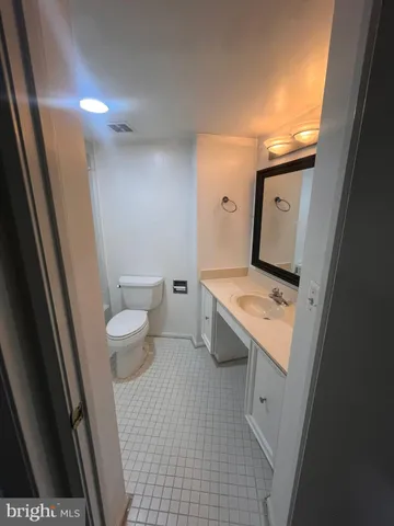 a view of bathroom with a toilet sink and mirror
