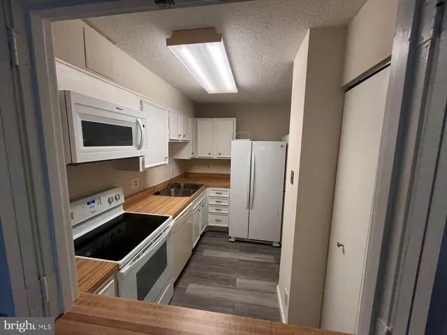 a kitchen with a stove and a refrigerator