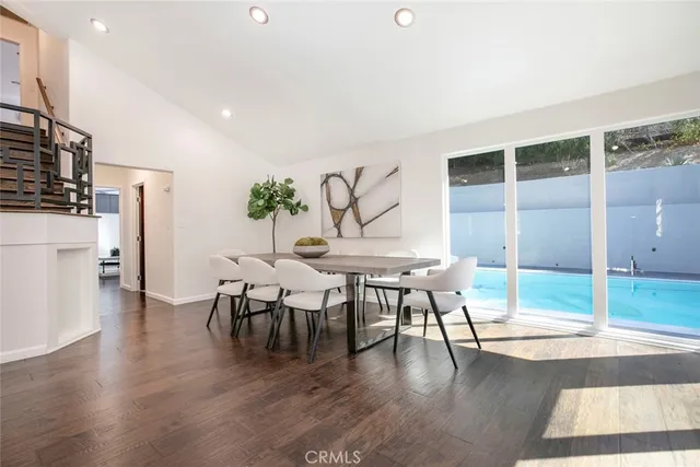 a view of a dining room with furniture and wooden floor