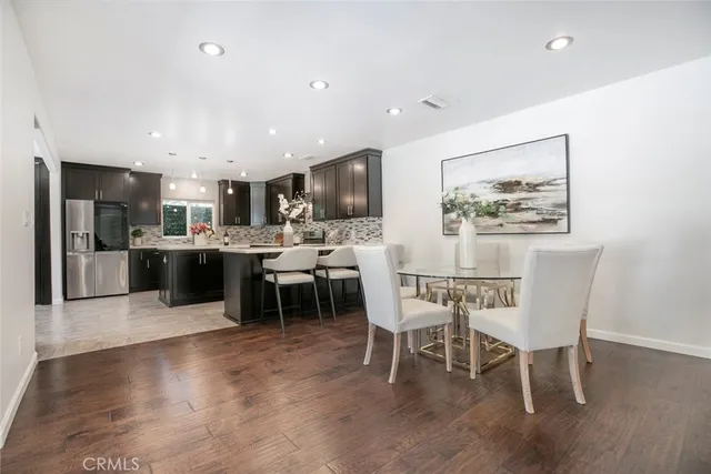 a dining room with furniture wooden floor and a rug