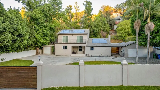 a view of tree in front of a house