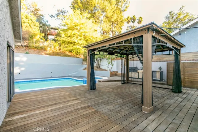 an aerial view of a house with swimming pool and garden