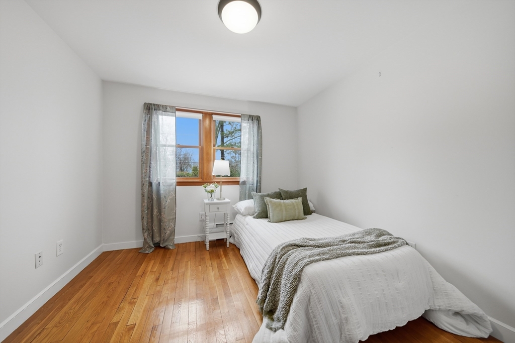 11 Lawrence Street Wakefield, MA 01880 - Photo 19 of 42 a bedroom with a bed and a window