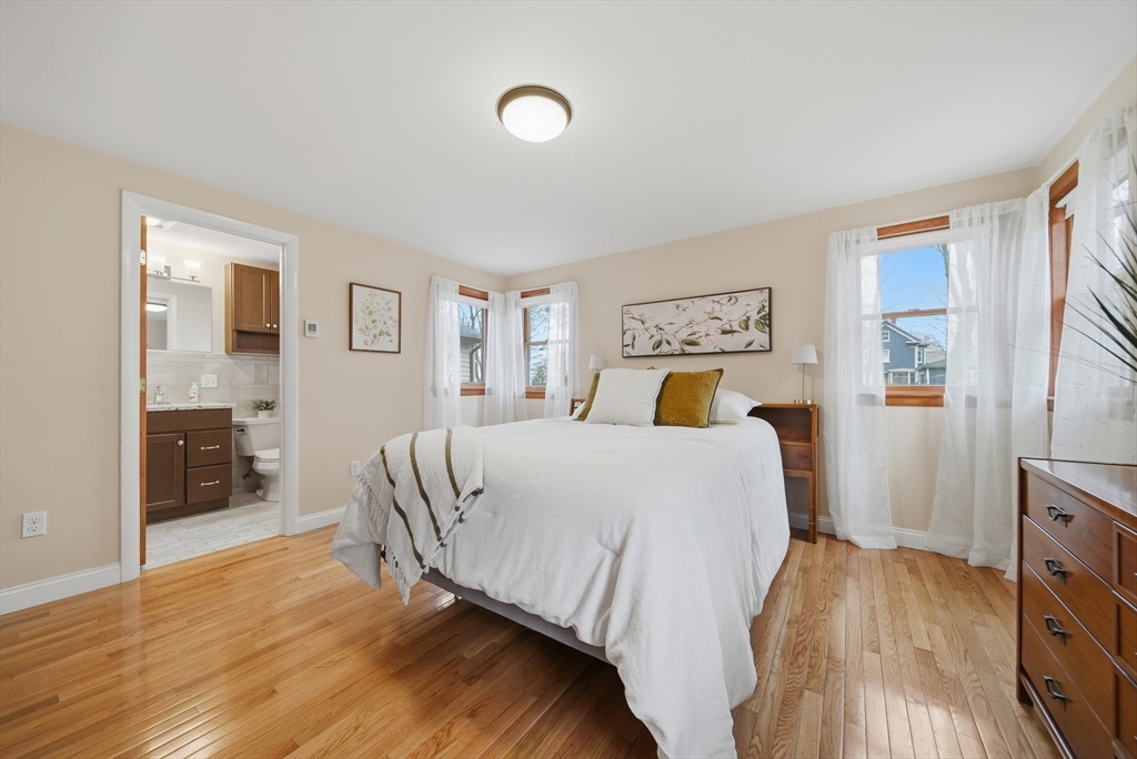 11 Lawrence Street Wakefield, MA 01880 - Photo 23 of 42 a bedroom with a bed and wooden floor