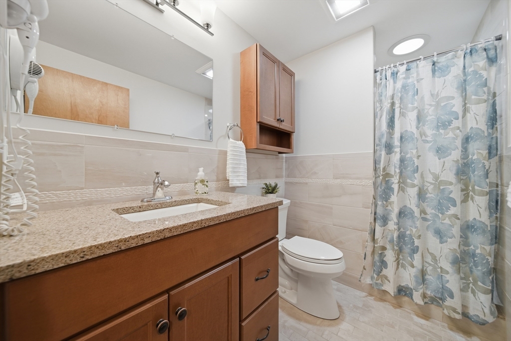 11 Lawrence Street Wakefield, MA 01880 - Photo 26 of 42 a bathroom with a granite countertop sink toilet and shower