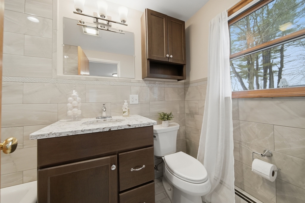11 Lawrence Street Wakefield, MA 01880 - Photo 27 of 42 a bathroom with a granite countertop toilet sink and mirror