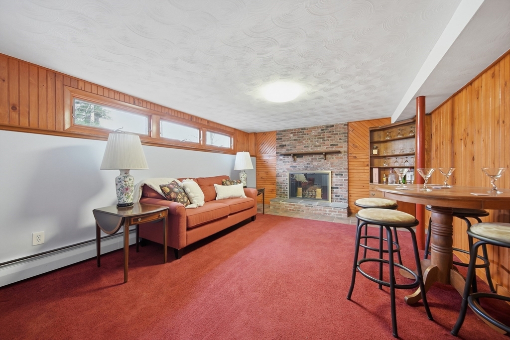 11 Lawrence Street Wakefield, MA 01880 - Photo 29 of 42 a living room with furniture and a fireplace