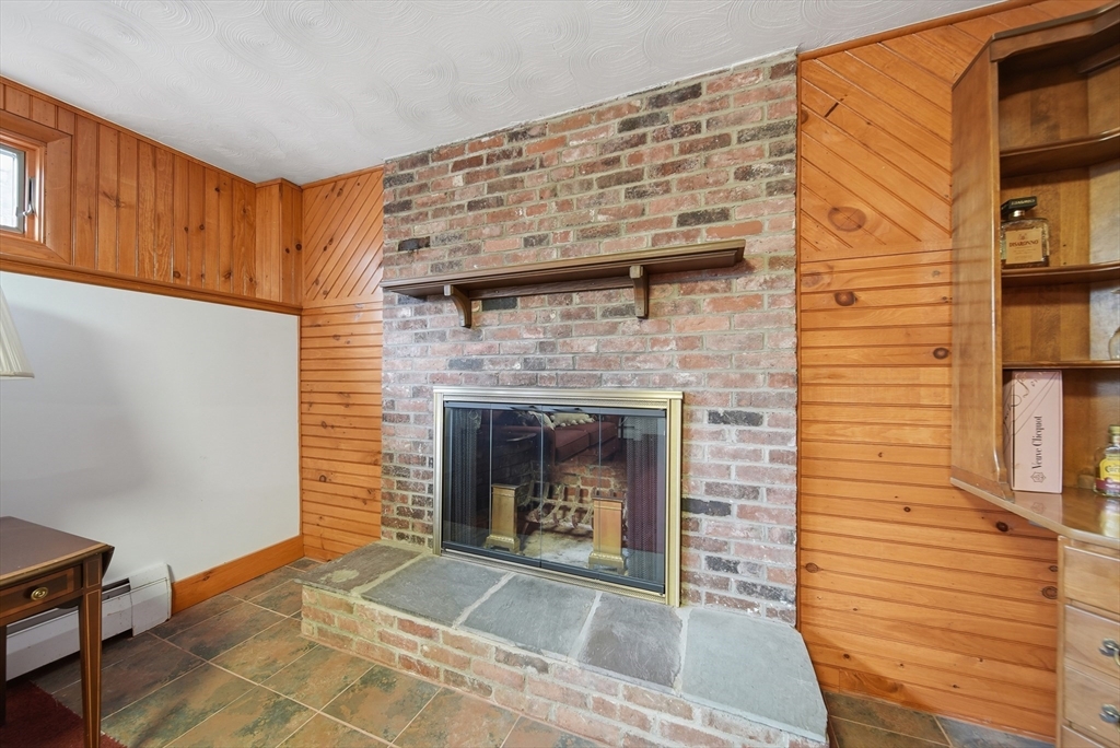 11 Lawrence Street Wakefield, MA 01880 - Photo 30 of 42 a living room with furniture and a fireplace