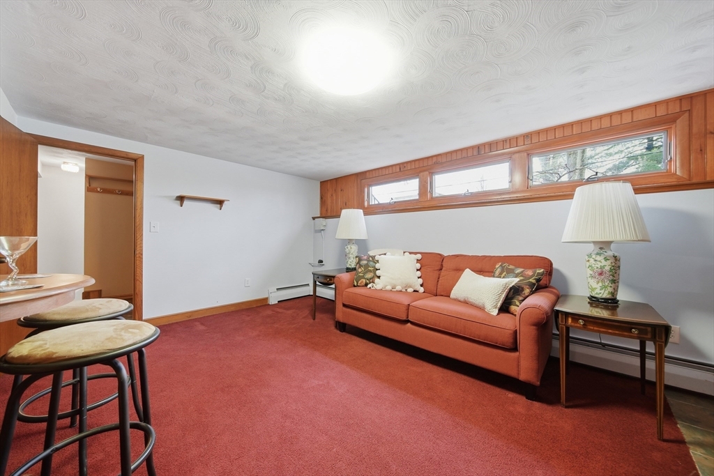 11 Lawrence Street Wakefield, MA 01880 - Photo 31 of 42 a living room with furniture a rug and a window