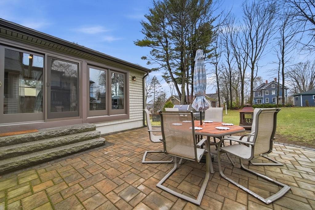 11 Lawrence Street Wakefield, MA 01880 - Photo 33 of 42 a view of a patio with table and chairs with wooden floor and fence