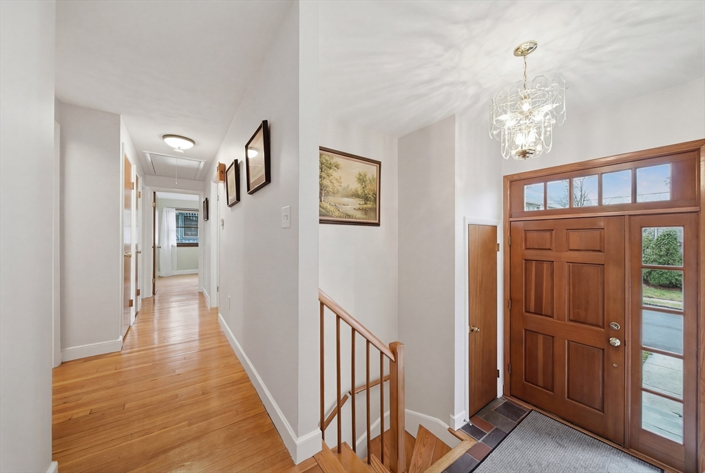 11 Lawrence Street Wakefield, MA 01880 - Photo 4 of 42 a view of a hallway with wooden floor and staircase
