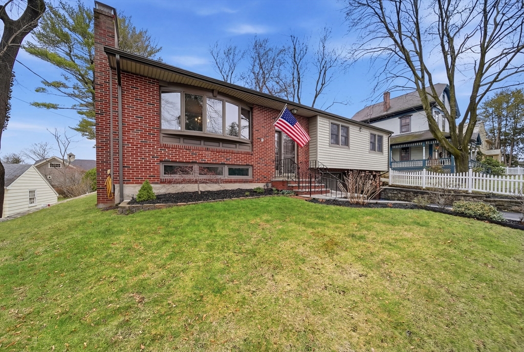 11 Lawrence Street Wakefield, MA 01880 - Photo 41 of 42 a front view of a house with a yard table and chairs