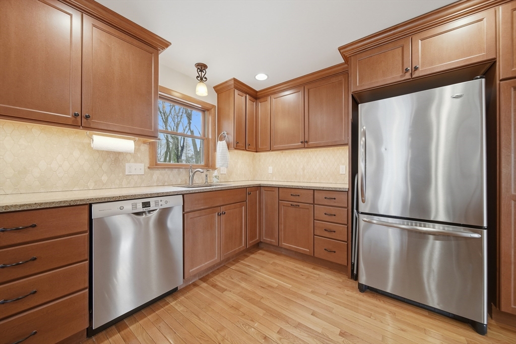 11 Lawrence Street Wakefield, MA 01880 - Photo 9 of 42 a kitchen with stainless steel appliances granite countertop a refrigerator sink and cabinets