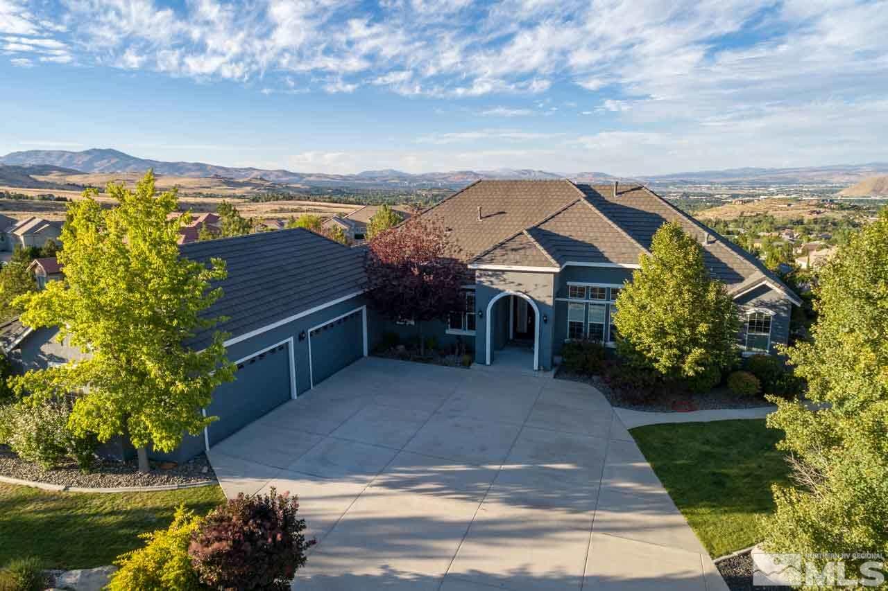 815 Peacepipe Loop Reno, NV 89511 - Photo 2 of 25 a view of house with swimming pool and mountains in the background