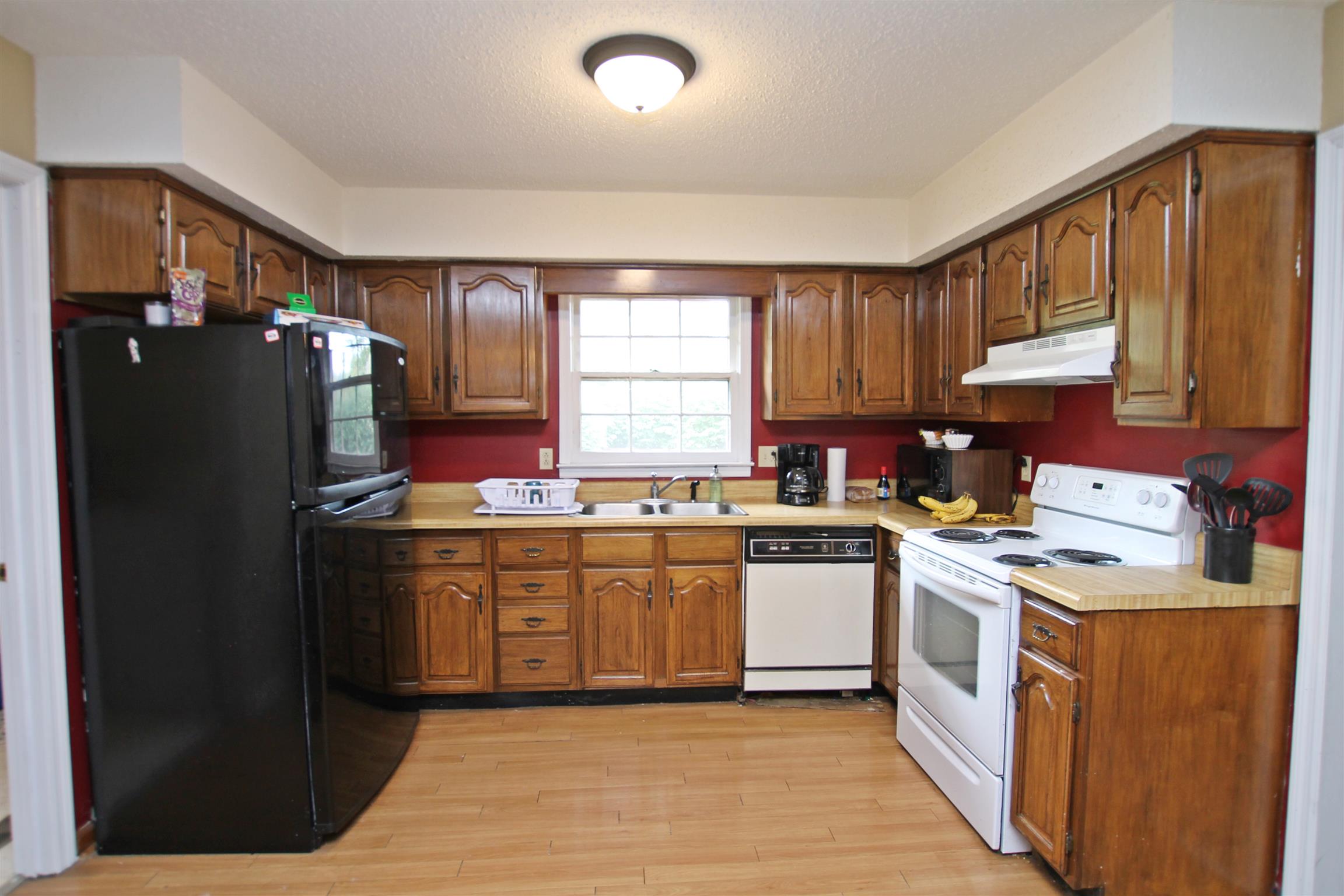 706 3rd Avenue West Springfield, TN 37172 - Photo 11 of 26 a kitchen with stainless steel appliances granite countertop a stove a refrigerator a sink dishwasher and a refrigerator