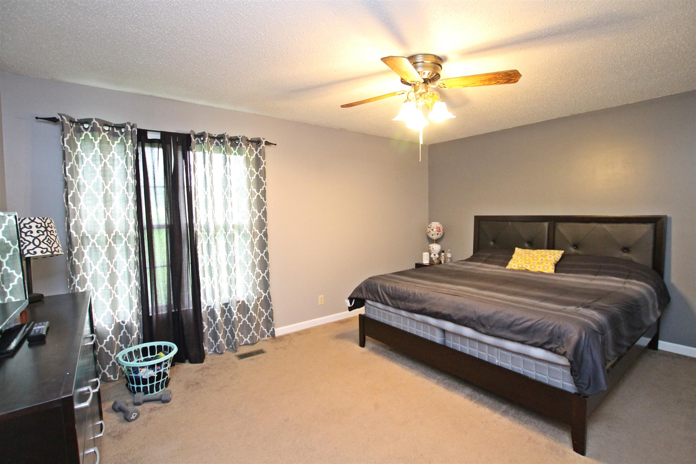 706 3rd Avenue West Springfield, TN 37172 - Photo 12 of 26 a bedroom with a bed and a chandelier