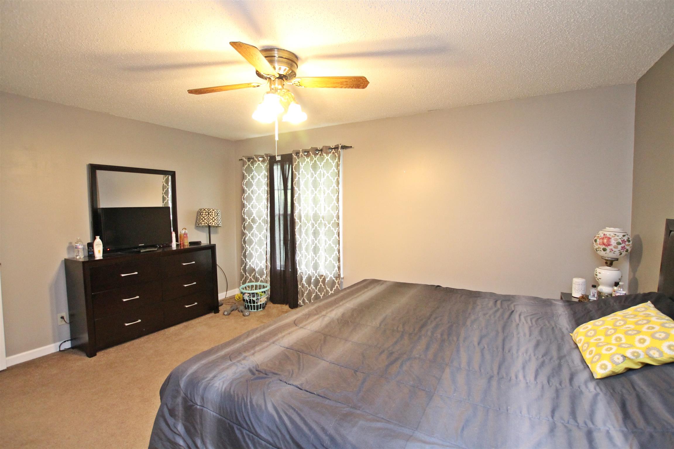 706 3rd Avenue West Springfield, TN 37172 - Photo 15 of 26 a bedroom with a bed and a chandelier