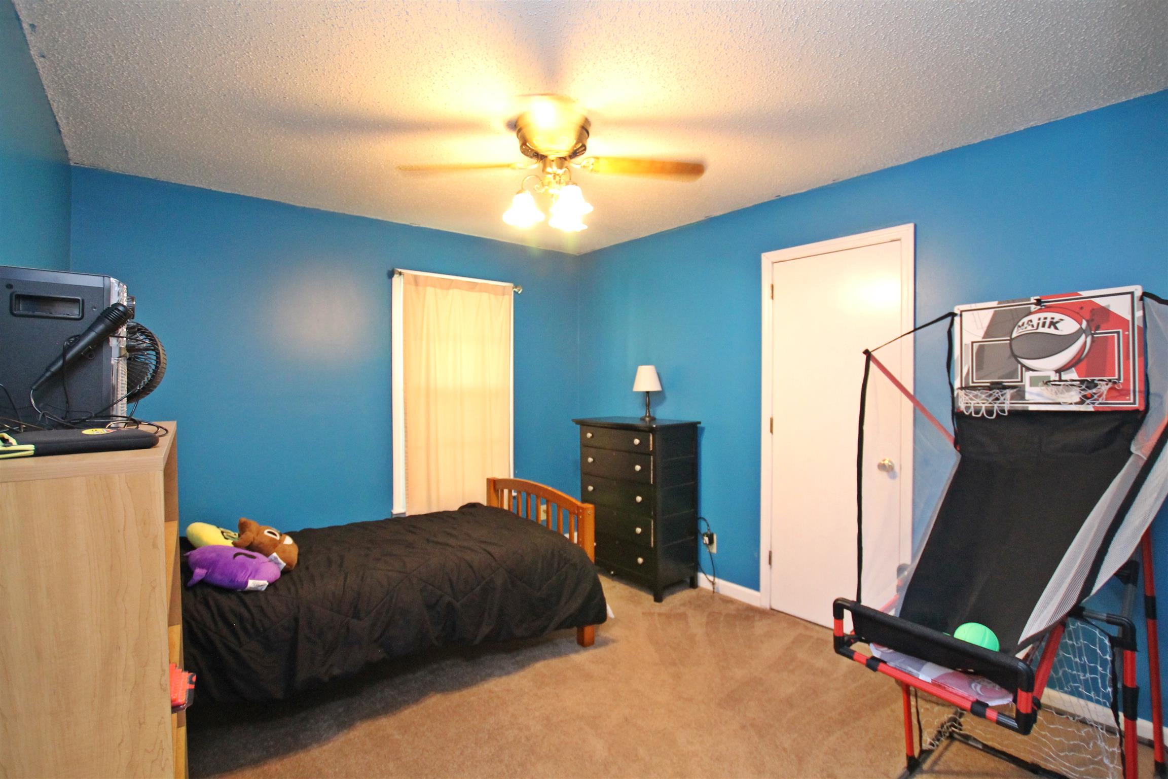 706 3rd Avenue West Springfield, TN 37172 - Photo 20 of 26 a bedroom with a bed and a flat tv screen on dresser
