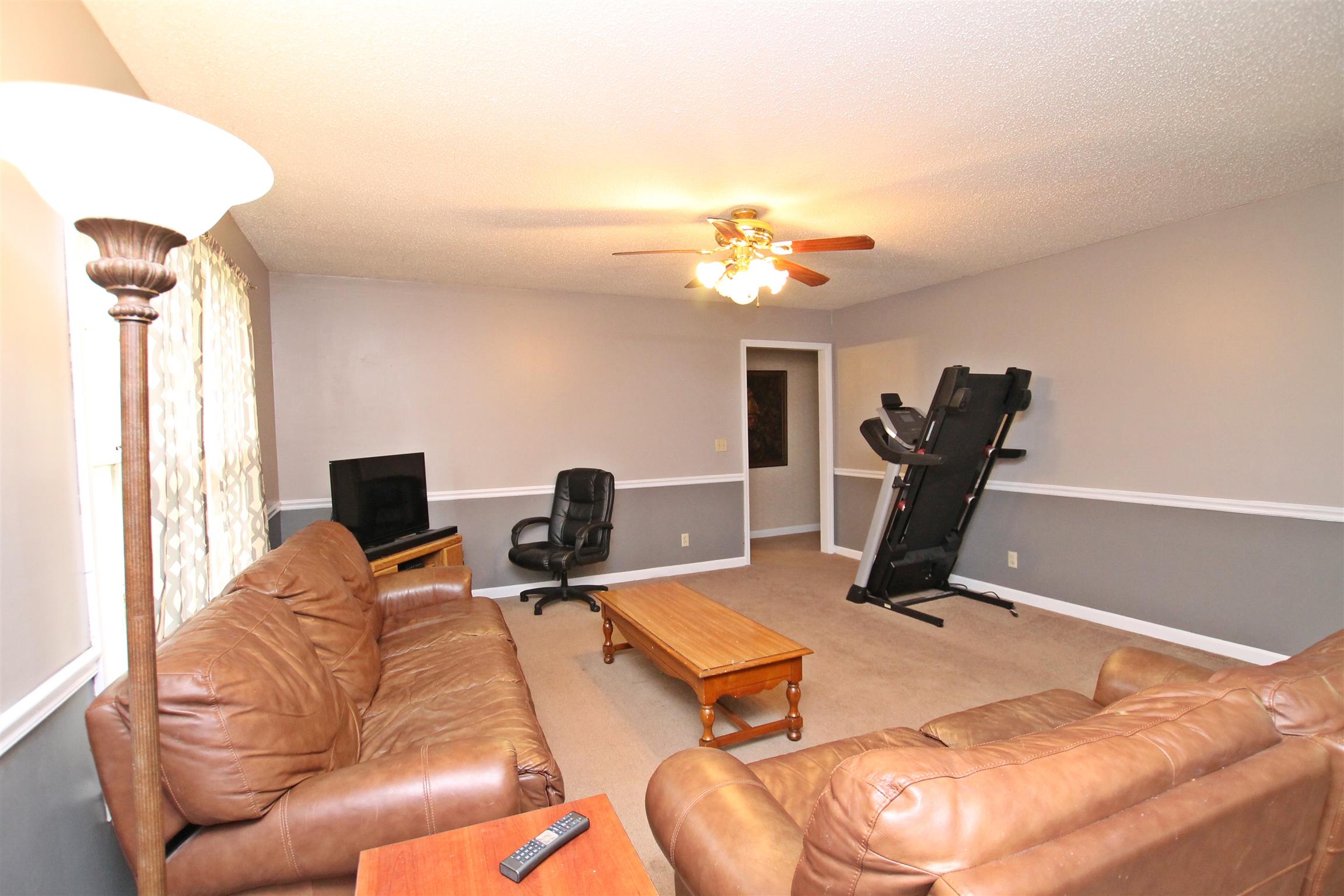 706 3rd Avenue West Springfield, TN 37172 - Photo 5 of 26 a living room with furniture a flat screen tv and a window