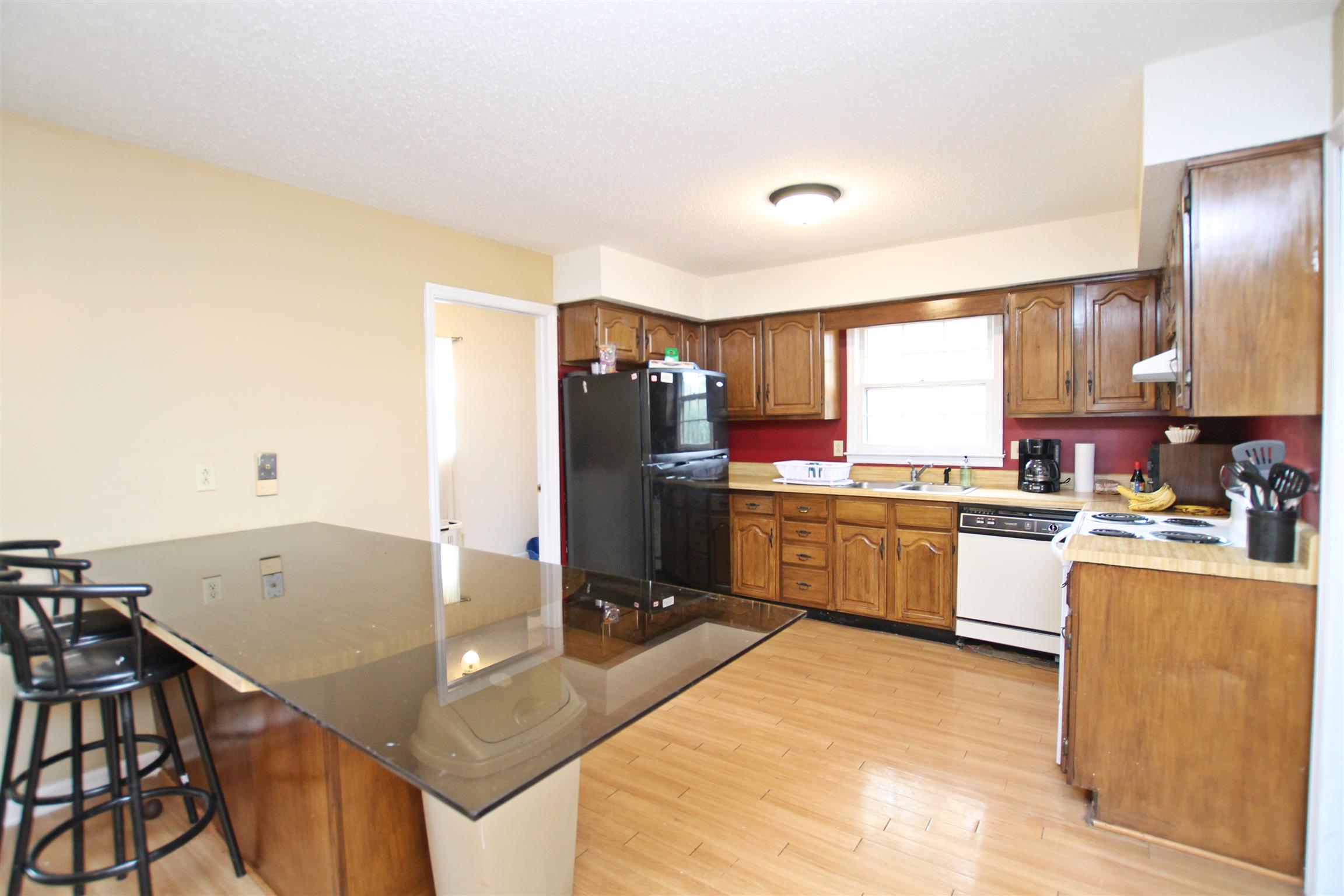 706 3rd Avenue West Springfield, TN 37172 - Photo 10 of 26 a kitchen with stainless steel appliances granite countertop a sink refrigerator and cabinets