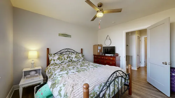 a bedroom with a bed and a chandelier