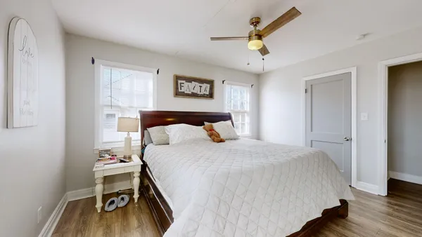 a bedroom with a bed and a chandelier