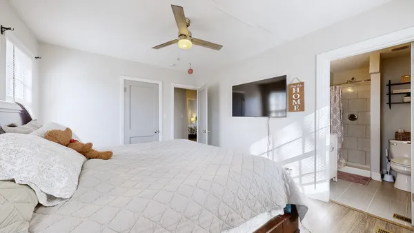 a bedroom with a bed and a chandelier