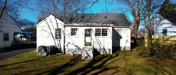 a view of house with a yard