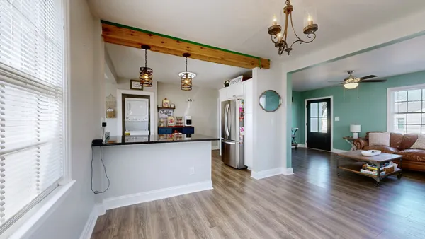 a living room with furniture and a chandelier